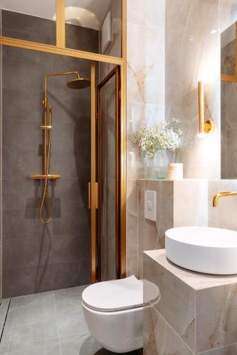a bathroom with a white toilet and a sink at Warsaw Story - LoftAffair Collection in Warsaw