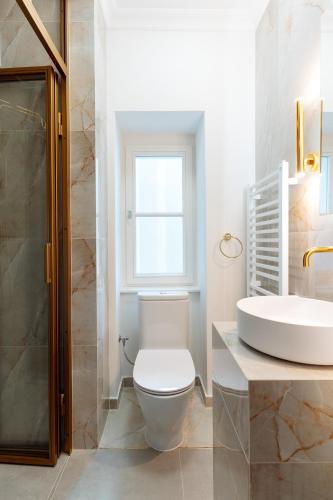 a bathroom with a toilet and a sink at Warsaw Story - LoftAffair Collection in Warsaw