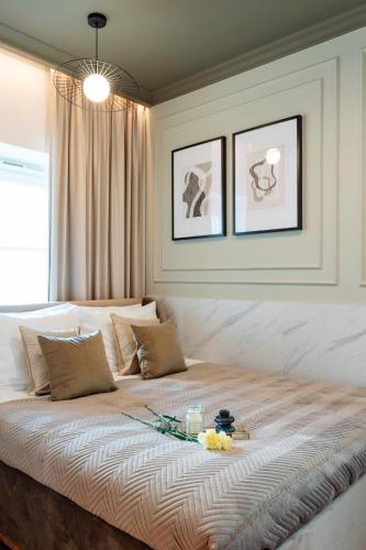 a bedroom with a large bed with flowers on it at Warsaw Story - LoftAffair Collection in Warsaw