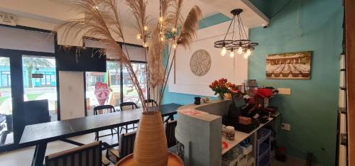 a dining room with a table and a vase at BREAKING DAWN- TAEYANG Hotel Phú Quốc in Phu Quoc