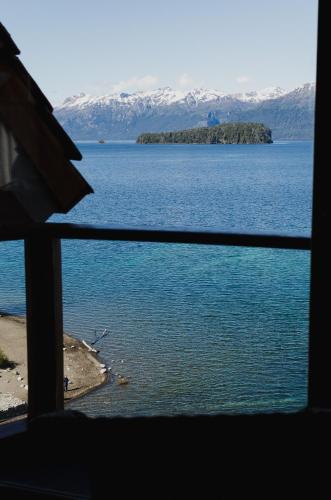 a view of a large body of water from a window at Correntoso Lake & River Hotel in Villa La Angostura