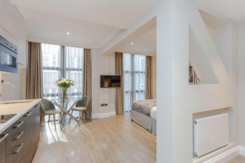 a bedroom with a bed and a table in a room at Cleveland Residences Farringdon in London