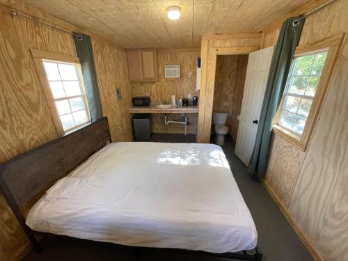 a bedroom with a bed in a small room at Reflection Cabin on Lake Godstone in Jacksboro