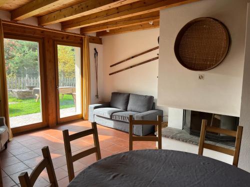 a living room with a couch and a fireplace at Eco Chalet Nonno Silvano in Bedollo