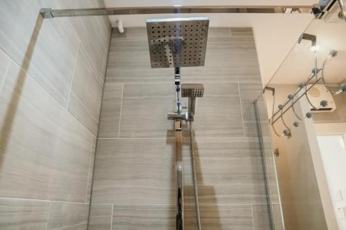 a shower in a room with a tile floor at 14 Burnett House by Prestige Properties SA in Seascale