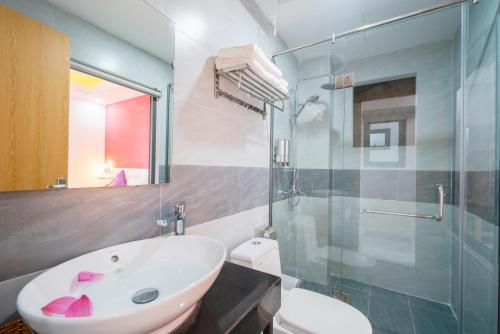 a bathroom with a sink and a shower and a toilet at Sen Hotel Phu Quoc in Phu Quoc