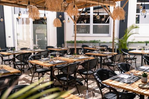 a row of tables in a room with windows at Boutique Hotel Societe in Baden-Baden