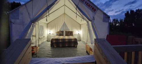 a large tent with a bed inside of it at Tentrr Signature Site - Little Creek Ranch in Waynesboro