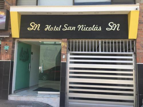 a front door of a store with a sign on it at Hotel San Nicolas in Bucaramanga