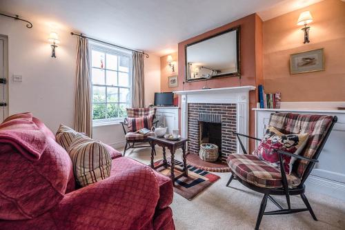 a living room with a couch and a fireplace at The Bolt Hole in Southwold in Southwold