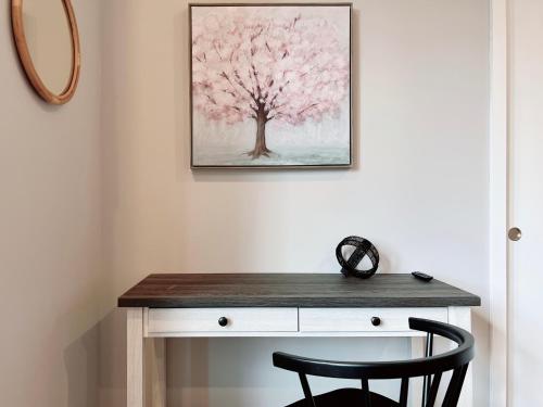 a desk with a pink tree on the wall at Stay at Luna on Ridge Ave in Philadelphia
