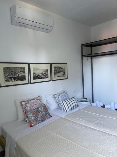 a bedroom with a bed with two pillows on it at Niriides Hotel Apartments in Symi