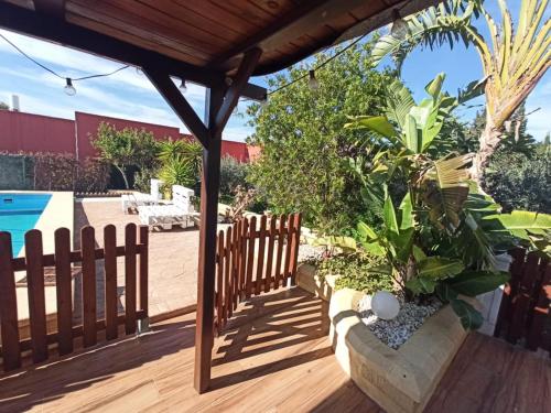 a wooden deck with a wooden fence and some plants at Cortijo Indalo in Pechina