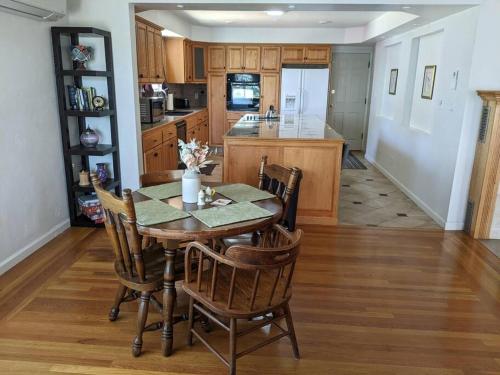 a kitchen with a table and chairs and a kitchen with a counter at A lake, a mountain and the house with the red door in Clearlake