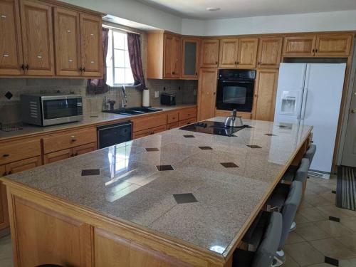 a large kitchen with a large island in the middle at A lake, a mountain and the house with the red door in Clearlake