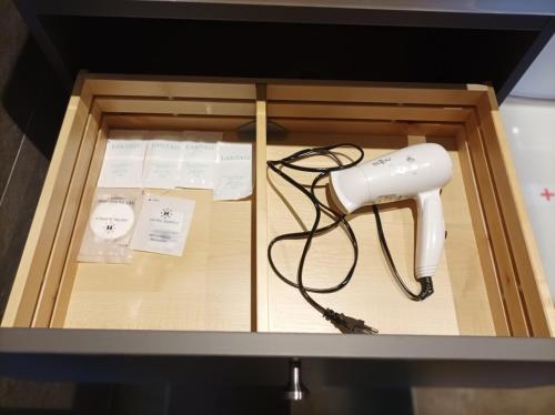 a blow dryer in a drawer of a cabinet at Horizont Dedine in Golubac