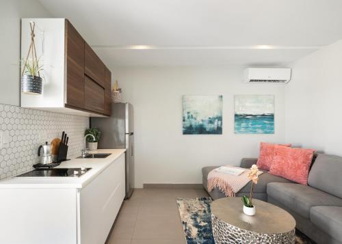 a kitchen and a living room with a couch and a table at Rosalina Ocean Park in San Juan