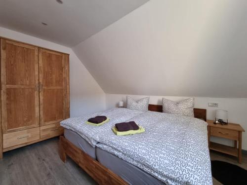 a bedroom with a bed and a wooden cabinet at Ferienwohnung Mack 1 in Wernigerode