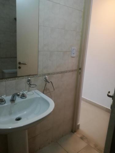 a bathroom with a white sink and a mirror at EL MONO DE YUYI in San Miguel de Tucumán