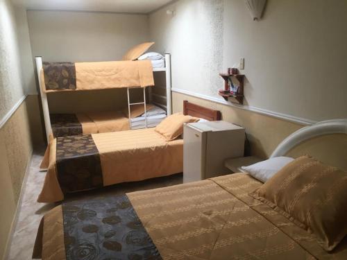 a room with two bunk beds in a room at Hotel San Nicolas in Bucaramanga