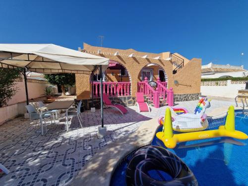 a pool with a water park with a water slide at Villa pink Ambience in Mazarrón