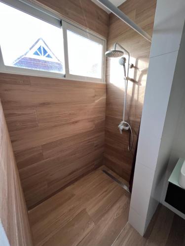 a shower in a tiny house with wood paneling at Ducassi Sol Caribe Beach in Punta Cana