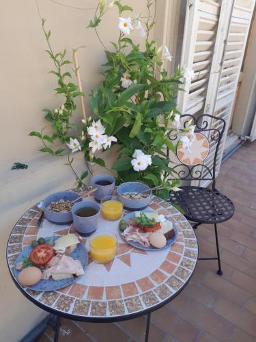 une table avec des assiettes de nourriture et des fleurs dans l'établissement Ballerina Bianca bed & breakfast, à Grottazzolina