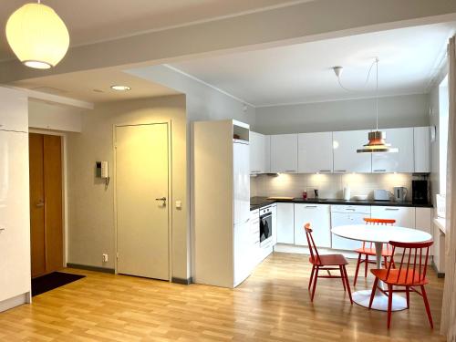 a kitchen and dining room with a table and chairs at Villa Centralen in Helsinki