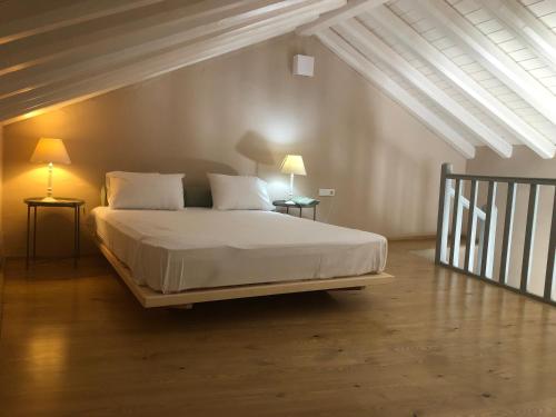 a bedroom with a bed with two lamps on two tables at KATIKIA ZAGORI in Vitsa