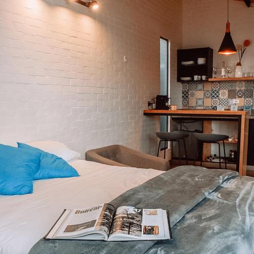 a book on a bed in a room at Tiny Houses Premium - Casa Barcelona in Duitama
