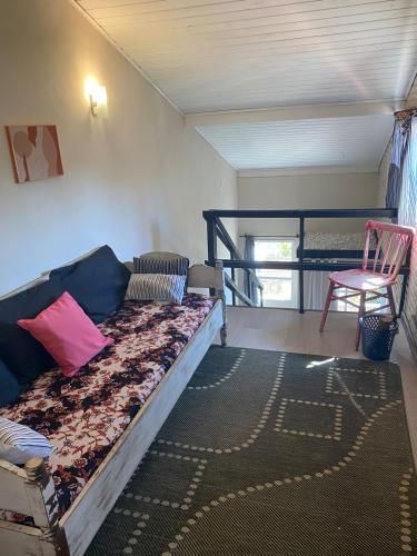 a room with a bed and a chair in a room at Pousada Vale das Flores in Nova Friburgo
