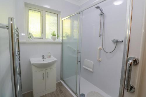 a bathroom with a shower and a sink at Yngywidden in Penzance