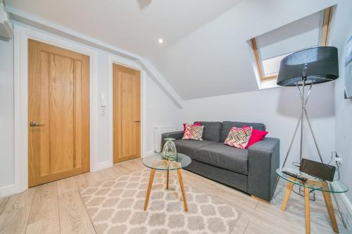 a living room with a couch and a table at 14 Helena House One Bedroom Apartment in Reading