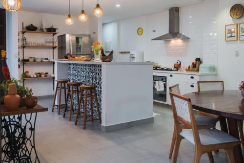 a kitchen with a table and chairs and a counter top at Casa de Praia Areia Vermelha in Cabedelo