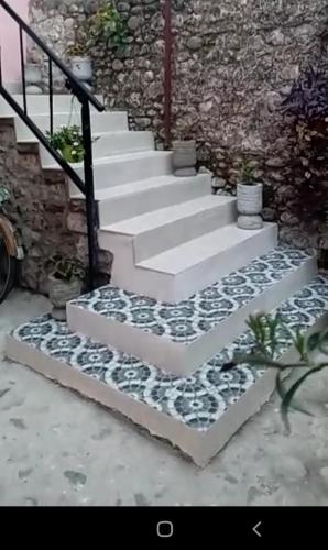 a set of stairs with rocks on them at Rooms for Rent in Shkodër