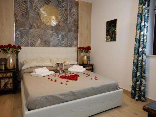 a bedroom with a bed with red roses on it at Caserta Royale Suite in Caserta