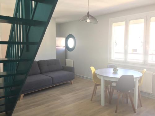 a living room with a couch and a table at Bel appartement duplex L'OPALE classé 3* 8P in Étaples