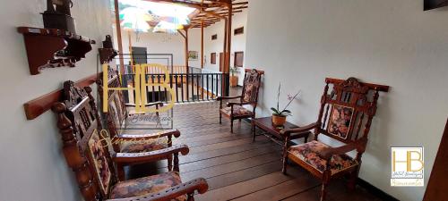 a hallway with rocking chairs and a staircase in a house at HOTEL BOUTIQUE SIMACOTA in Simacota