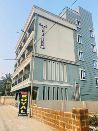 a blue building with a sign in front of it at Royal Beach International in Puri