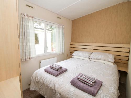a bedroom with a bed with two towels on it at 3 Old Orchard in Much Wenlock