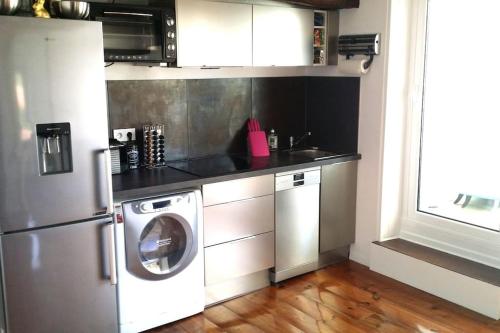 Il comprend une cuisine équipée d'un lave-linge et d'un lave-vaisselle. dans l'établissement T2 à Anglet grande terrasse vue mer, plage à pied., à Anglet