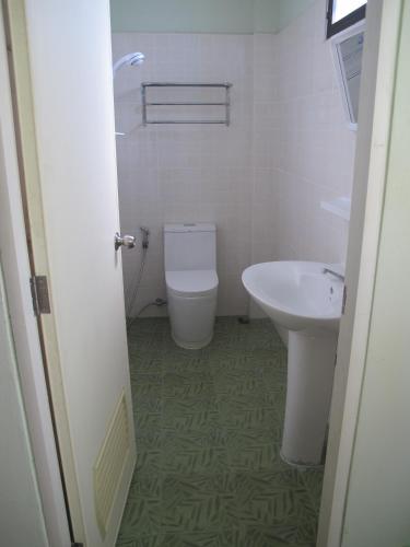 a bathroom with a toilet and a sink at The Star Hotel in Udon Thani