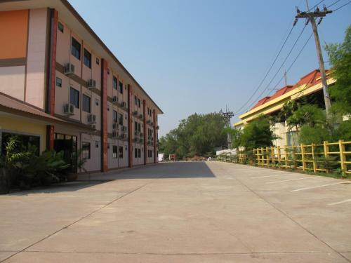 an empty street in front of a building at The Star Hotel in Udon Thani