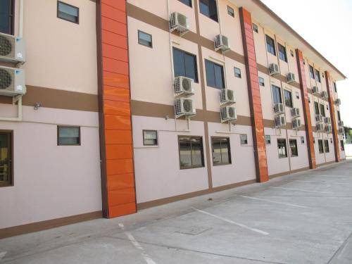 an empty parking lot in front of a building at The Star Hotel in Udon Thani