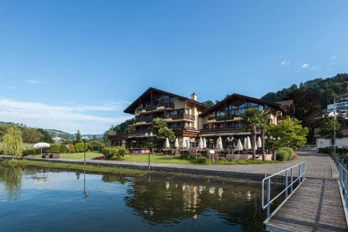 a building next to a river with a house at Seehotel Sternen in Luzern