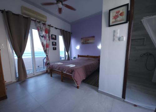 a bedroom with a bed and a walk in shower at Anna Studios in Myrties