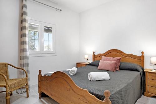 a bedroom with a bed and a chair and a window at Villa Montenmedio 1 in El Soto