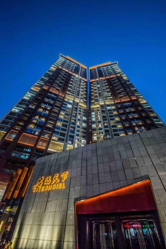 a tall building with a sign in front of it at Somerset Grandview Shenzhen in Shenzhen