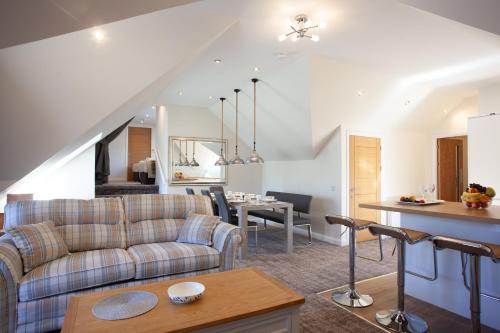 a living room with a couch and a table at Lochiel Villa Guest House in Fort William