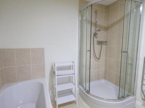 a bathroom with a shower and a sink and a tub at Park Cottage in Ambleside
